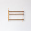 wall hung wooden shelving by John Eadon with three shelves, minimal
