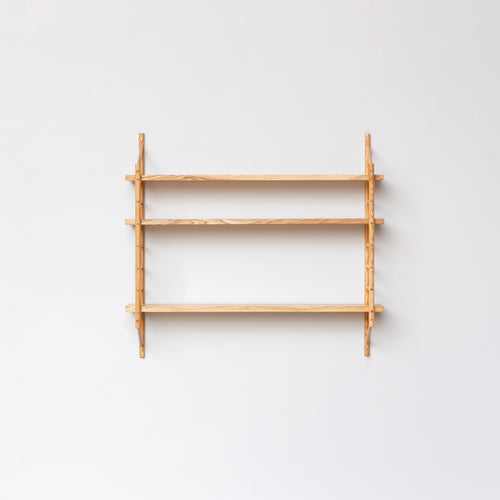wall hung wooden shelving by John Eadon with three shelves, minimal