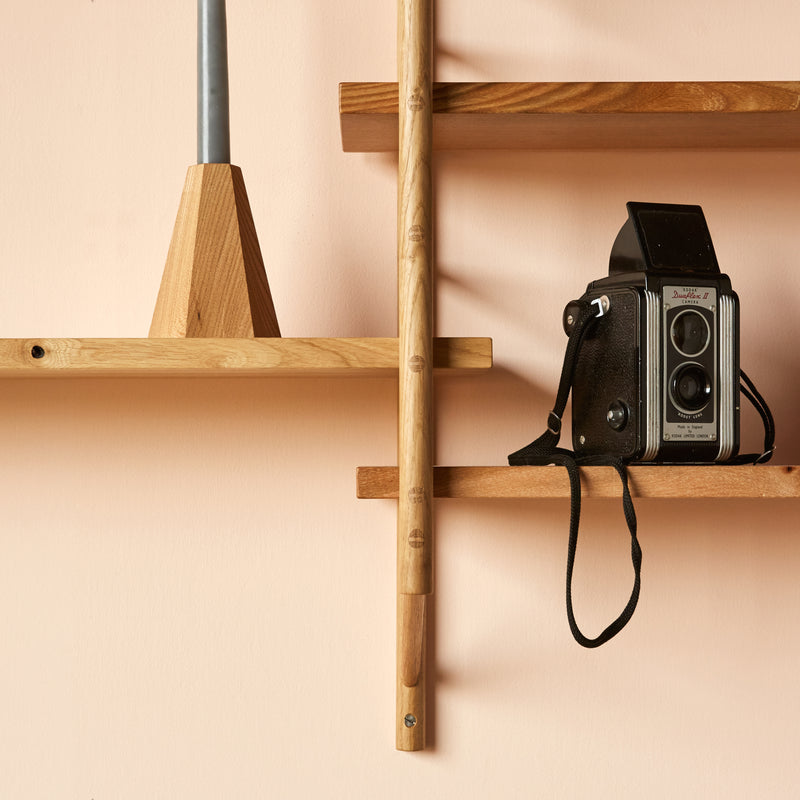 wooden shelving with vintage camera