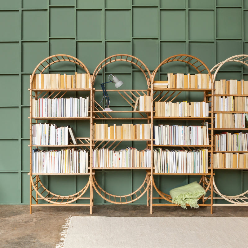 arched freestanding wooden ladder shelving by John Eadon with books