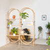 arched freestanding wooden ladder shelving by John Eadon used as a room divider